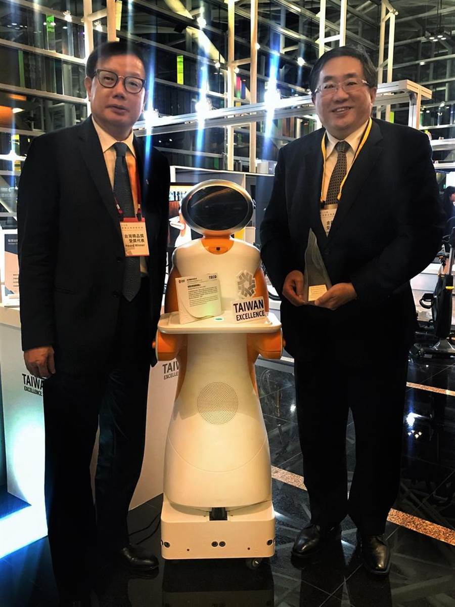 （東元電機(jī)自行開發(fā)送餐機(jī)器人27日獲頒臺灣精品獎銀質(zhì)獎，圖右為代理總經(jīng)理連昭志、左為負(fù)責(zé)開發(fā)的東元電機(jī)自動化暨智能系統(tǒng)事業(yè)部協(xié)理林勝泉。圖／業(yè)者提供）
